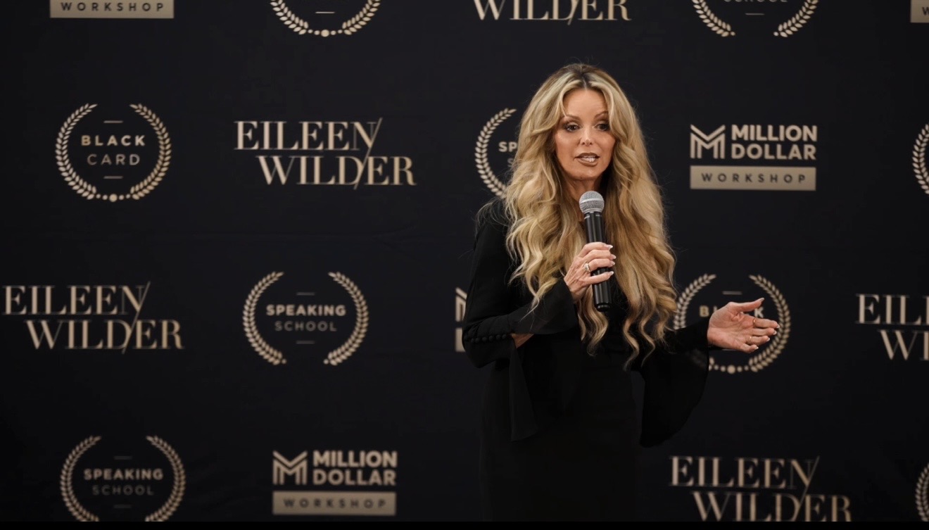 Bobbi Higgins speaking on stage with a microphone